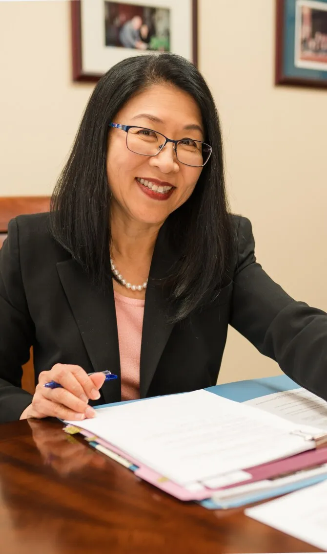Attorney Kimberly T. Lee reviewing client files at her desk
